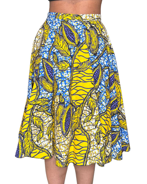 Jupe midi wax jaune et bleue aux motifs feuillages tropicaux. Taille haute, coton 100 %, confection artisanale française.